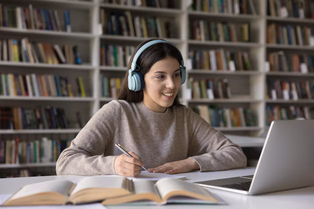 Student practicing for TOEFL with headphones